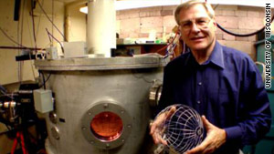 Gerald Kulcinski, a professor at the University of Wisconsin, holds the grid for his team's fusion device.
