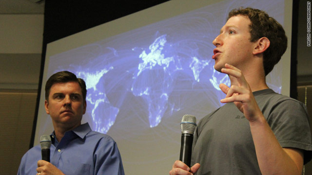 Skype CEO Tony Bates listens Wednesday as Facebook's Mark Zuckerberg describes his site's new video chat feature.