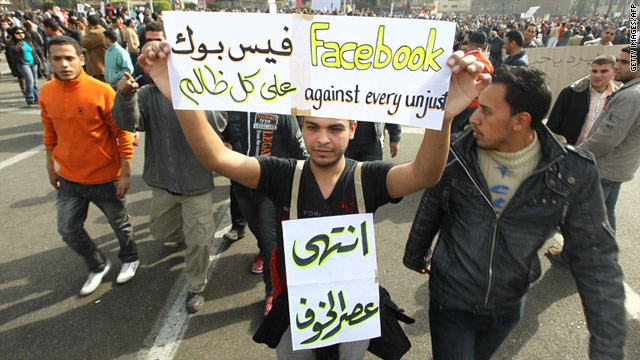 Internet access was returned to parts of Egypt on Wednesday. A protester on Tuesday holds up a sign in support of Facebook.