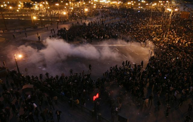 Photo: Mohammed Abed/AFP/Getty Images. Riot police fired tear gas at anti-government protestors in Cairo who, inspired by the recent revolution in Tunisia, are demanding the resignation of their president.