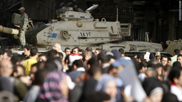 Egyptian demonstrators gather in Cairo's Tahrir Square close to a military tank on Monday.