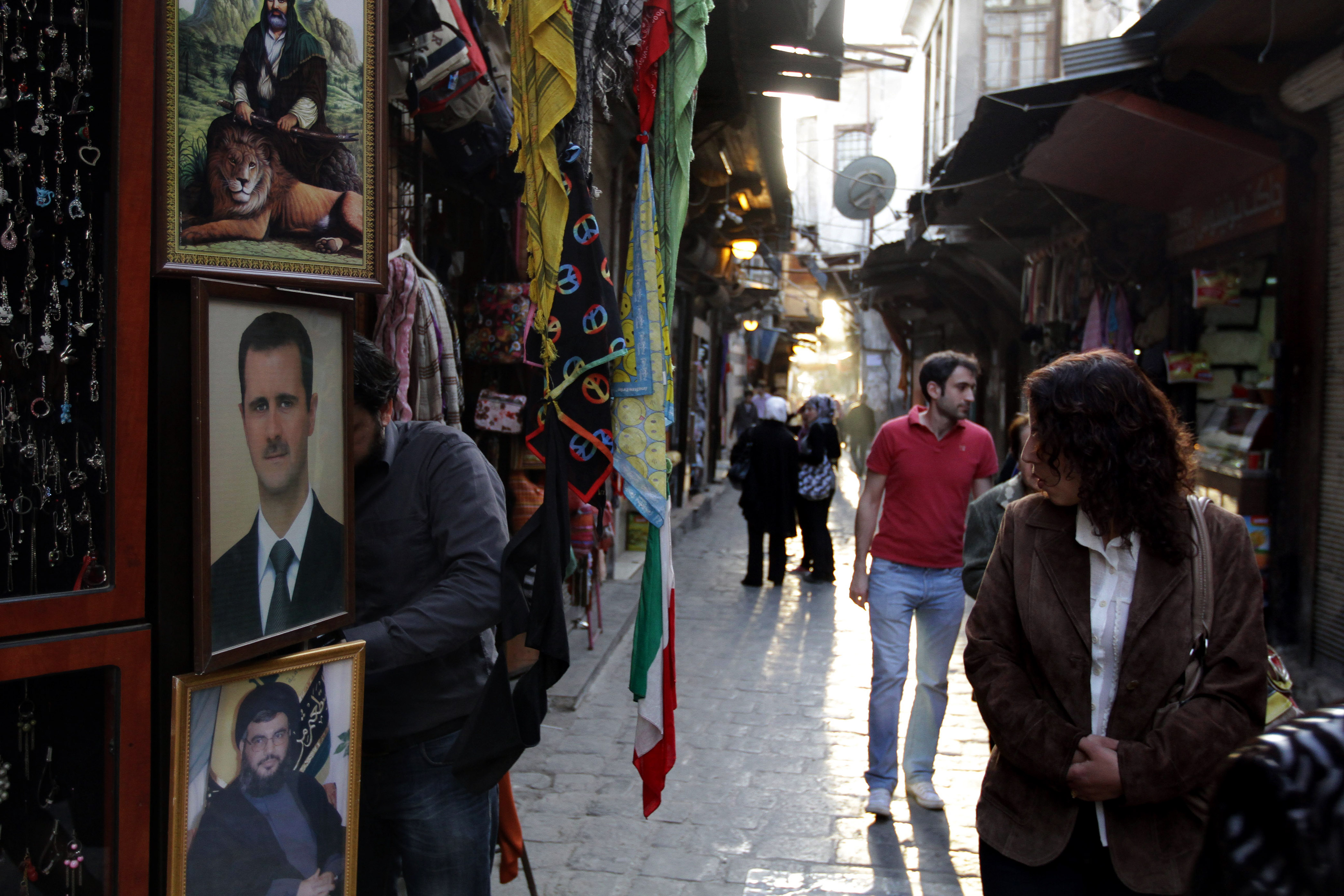 A picture of Syrian President Bashar al-Assad at the entrance of a store at a market in Damascus.