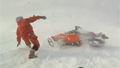 Snowmobile crash nearly crushes driver