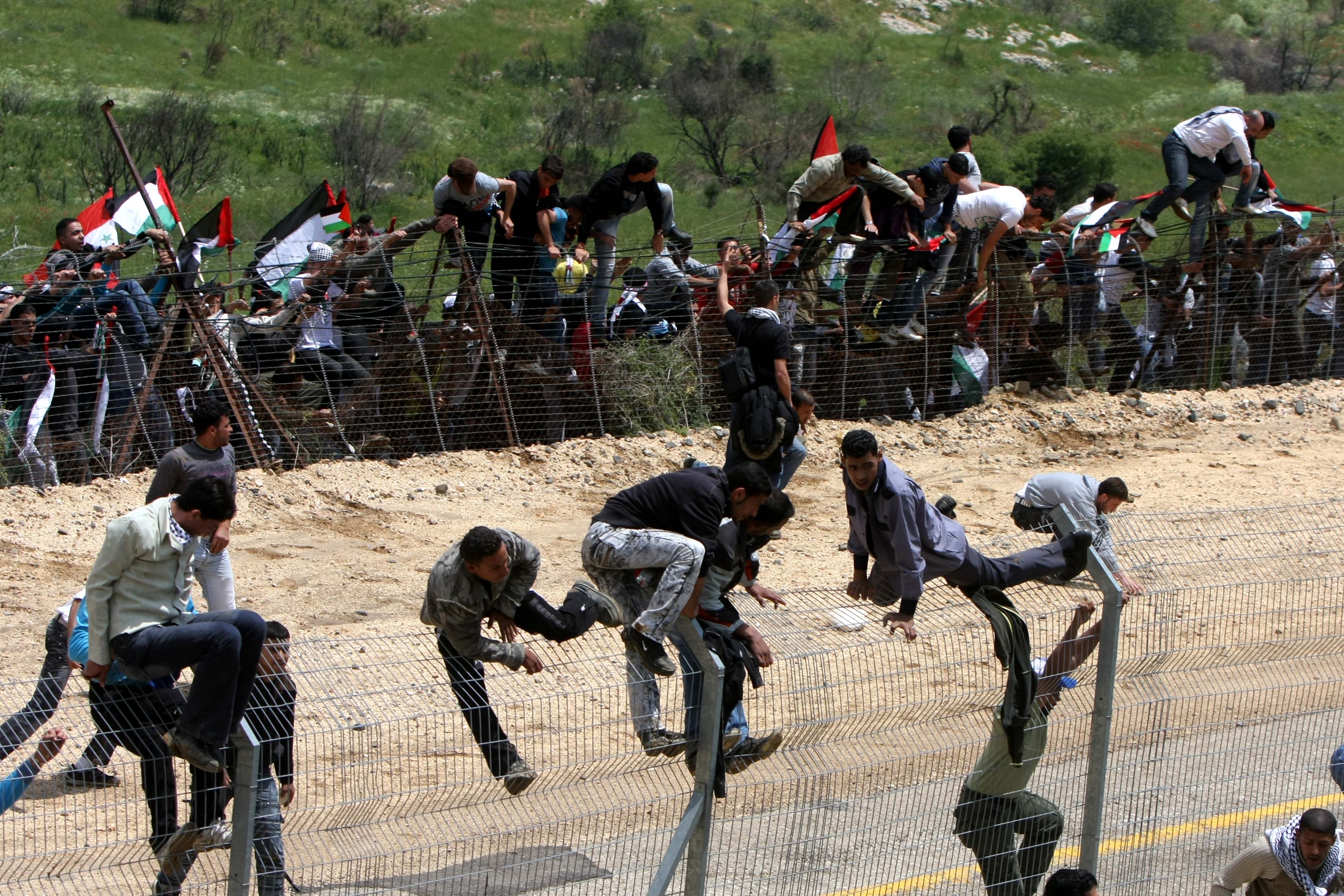 Palestinian protesters infiltrate the Israel-Syria border on May 15 near the Druze village of Majdal Shams. Reportedly at least twelve were killed and several injured when Israeli soldiers opened fire on protesters AFP/ Getty Images.