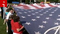 Hundreds help raise 60-foot 9/11 flag