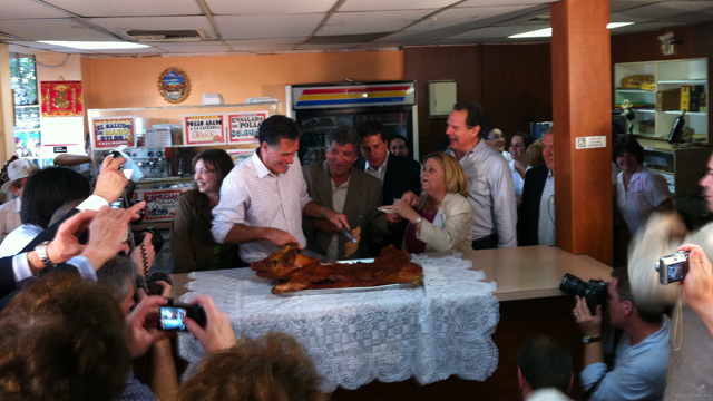 Photo: Romney cuts into a pig