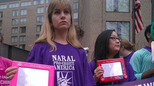 Abortion rights activists Etch A Sketch against Romney Abortion rights activists Etch A Sketch against Romney