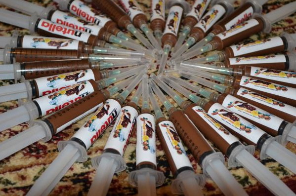 Rows of chocolate-filled syringes with fake Nutella packaging as posted on www.souq.dubaimoon.com