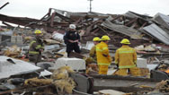 Rescue workers comb through the rubble