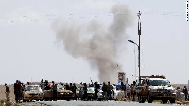 Gadhafi loyalists attack Libyan National Transitional Council fighters at an outpost near Bani Walid on Wednesday.