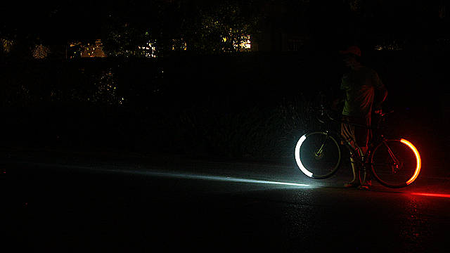 LED lights attached to wheel rims create a stunning glow of red and white light when the tires are in motion.