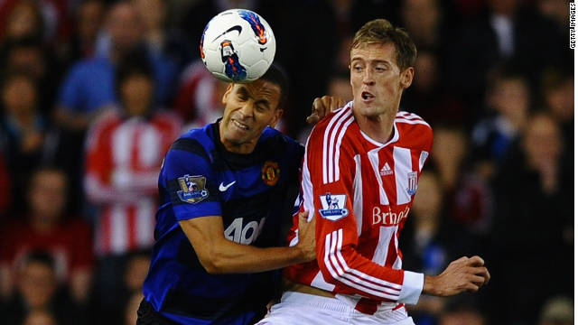 Stoke's goalscorer Peter Crouch, right, battles with Manchester United defender Rio Ferdinand.