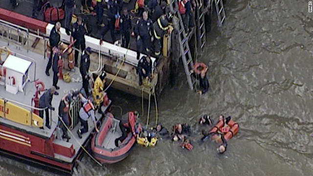 Rescuers pull people out of the East River after a helicopter crashed into the New York waterway.