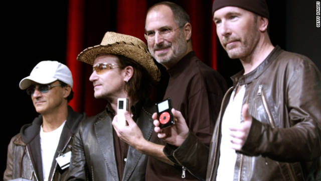 Jobs laughs with Jimmy Iovine, from left, Bono and The Edge of U2 at a celebration of the release of new iPod products in October 2004 in San Jose, California. 