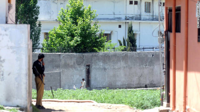 A Pakistani policeman stands guard in front of Osama bin Laden's former compound in Abbottabad on May 7.