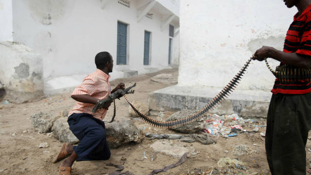 Hard-line islamist fighters exchange gun fire with government forces in Mogadishu on July 3, 2009.