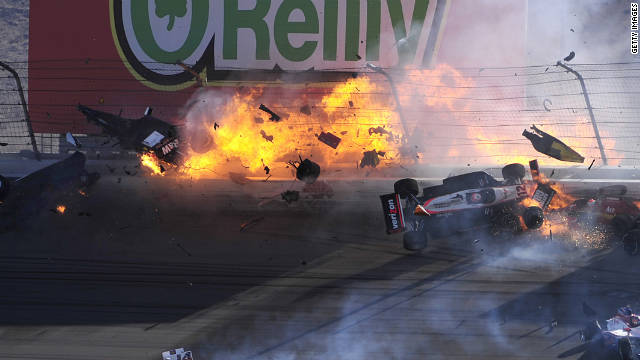 The car of Dan Wheldon disintegrates and bursts into flames in a 15-car pileup during Sunday's Las Vegas Indy 300. 