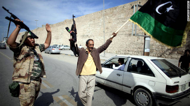 Libyan National Transitional Council fighters celebrate in the streets of Tripoli after news of Moammar Gadhafi's capture in Sirte on Thursday, October 20.