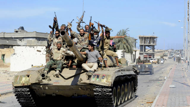 Libyan National Transitional Council fighters celebrate atop a tank in the coastal city of Sirte on Thursday.