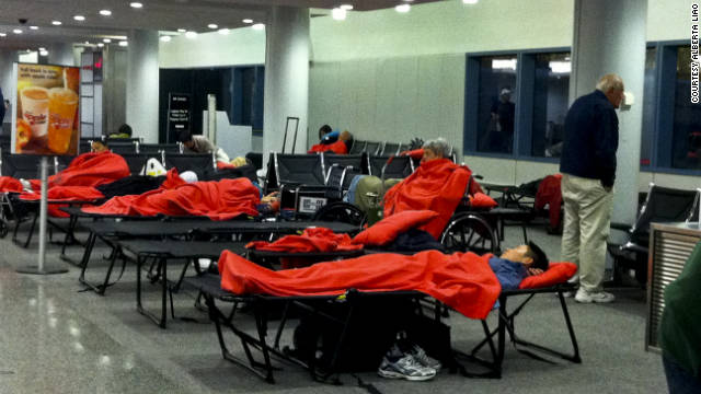 JetBlue passengers sleep on cots at Hartford, Connecticut's Bradley International Airport.