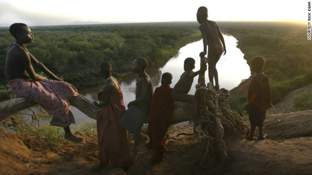 Children from the Kara tribe gather near the Omo River at dawn. None of them are considered "mingi." 