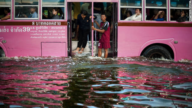 People stand on a bus as it makes its way through floodwater in the Lat Phrao district of Bangkok, November 7.