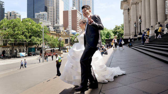 Miko and Billy Tsang walk down the steps of Victoria's State Parliament after being married in Melbourne, Australia, on November 11, 2011.