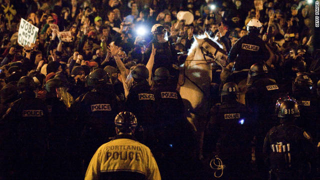 Police attempt to disperse a crowd at Occupy Portland on Sunday.