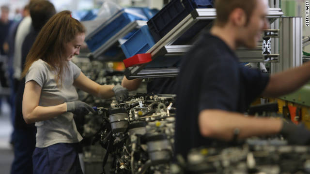 Workers assemble engines at the Mercedes car and truck engine factory in Berlin.