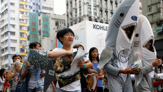 Supporters of the Hong Kong Shark Foundation march along a street to raise awareness for sharks killed each year for their fins, in Hong Kong on September 25.