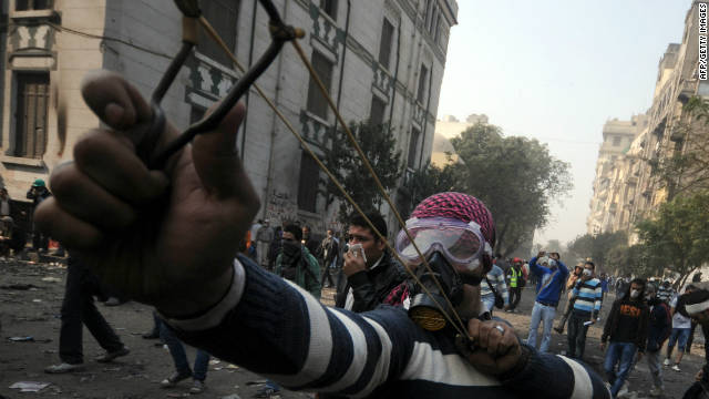 A young Egyptian fires a slingshot during clashes with police Tuesday in Tahrir Square.