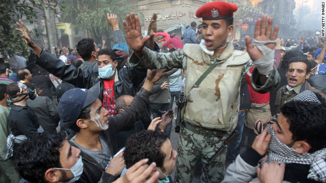 An Egyptian soldier attempts to control a crowd of protesters Tuesday in Tahrir Square.