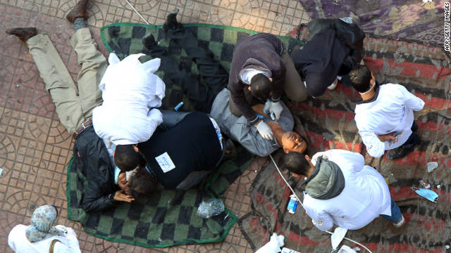 Doctors at a makeshift hospital in Tahrir Square tend to protesters hit by tear gas on Wednesday.