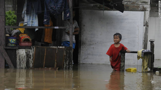 A boy cries as he stands in floodwaters outside his house in Thailand's southern province of Narathiwat on November 23.