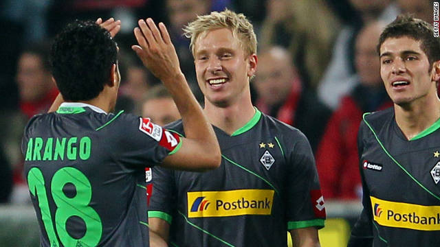 Moenchengladbach goalscorers Mike Hanke (center) and Jorge Arango celebrate their success