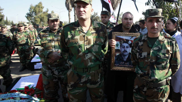 Syrian soldiers attend a funeral on November 26, 2011 of comrades reportedly killed in an ambush in the city of Homs.