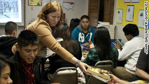 Professor Pamela Voekel hands out text books to Freedom University students