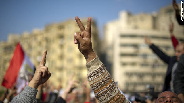 Anti-military rule protestors in Tahrir Square, await the outcome of recent elections .