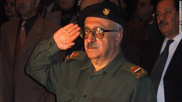 Tariq Aziz salutes the Iraqi national anthem during a 2001 event.