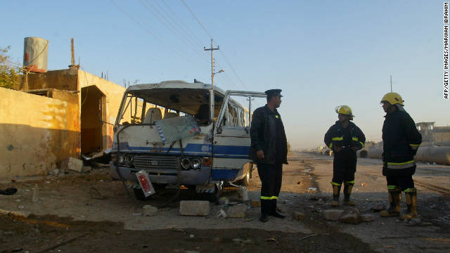 Iraqi firefighters inspect the site of a blast in Kirkuk on December 3.
