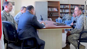 Rosenblatt, left, sits with other attorneys in Iraq, as they work to bring charges against a suspected insurgent.