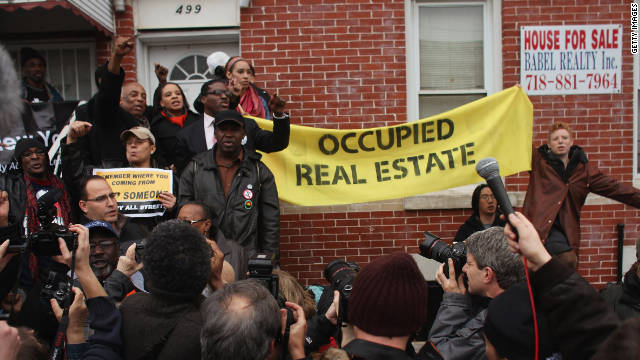 Members of the Occupy Wall Street movement rally around a foreclosed home during a march in East New York earlier this week.