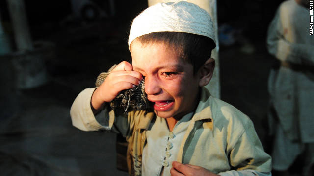 A young boy cries after being rescued by police. Police found the students chained together in the basement of the schoool.