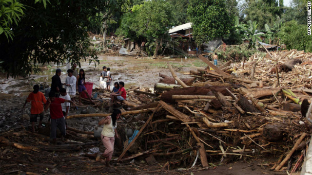Residents of Iligan City, in the southern Philippines, examine piles of debris after the storm.