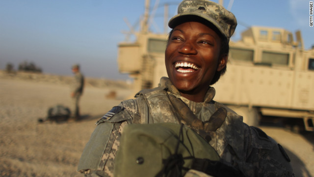 Specialist Shunterika Lewis from the 3rd Brigade, 1st Cavalry Division laughs while preparing to depart in the last convoy from Iraq at Camp Adder.