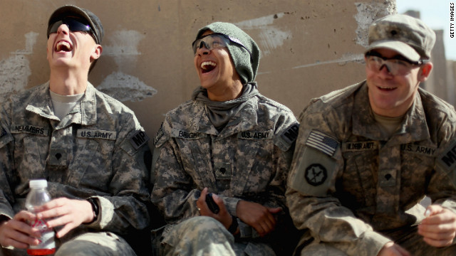 Soldiers (left to right) Peter Nemmers, Morgan Bright and Matthew Hildebrandt from the 3rd Brigade, 1st Cavalry Division laugh while preparing to depart from Iraq at Camp Adder.