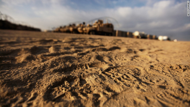 Boot footprints are seen in front of U.S. Mine Resistant Ambush Protected (MRAP) vehicles in the nearly deserted Camp Adder, now known as Imam Ali Base, on December 16.