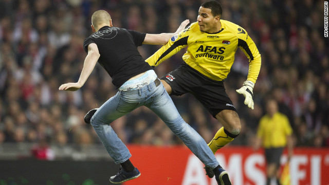 AZ Alkmaar goalkeeper Esteban kicks a man who attacked him from behind during the Dutch Cup match at Ajax.