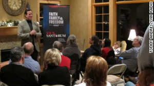 Santorum speaks in the Mitchell living room. The contender came with no entourage and no campaign bus.