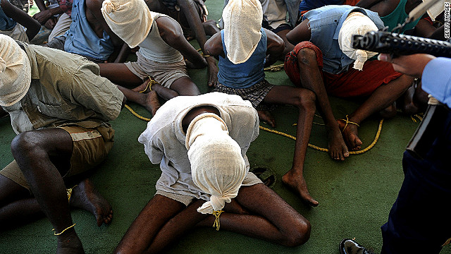 Suspected pirates sit with their faces covered on an Indian coast guard ship in this file picture dated February 10, 2011.